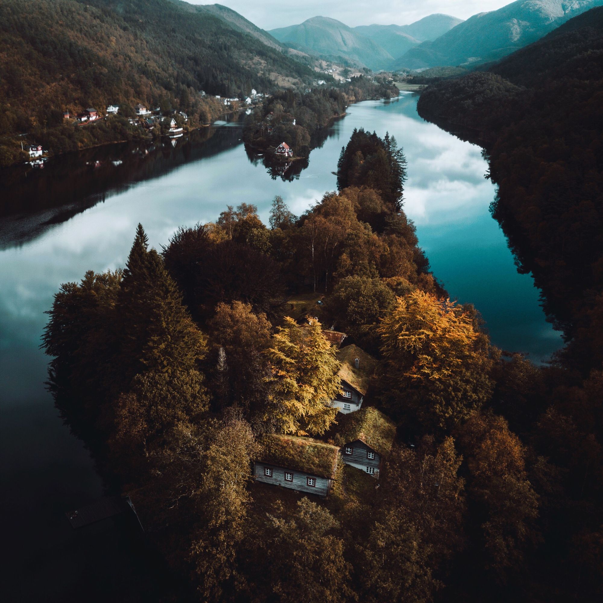 Cabins on an island in a fjord.